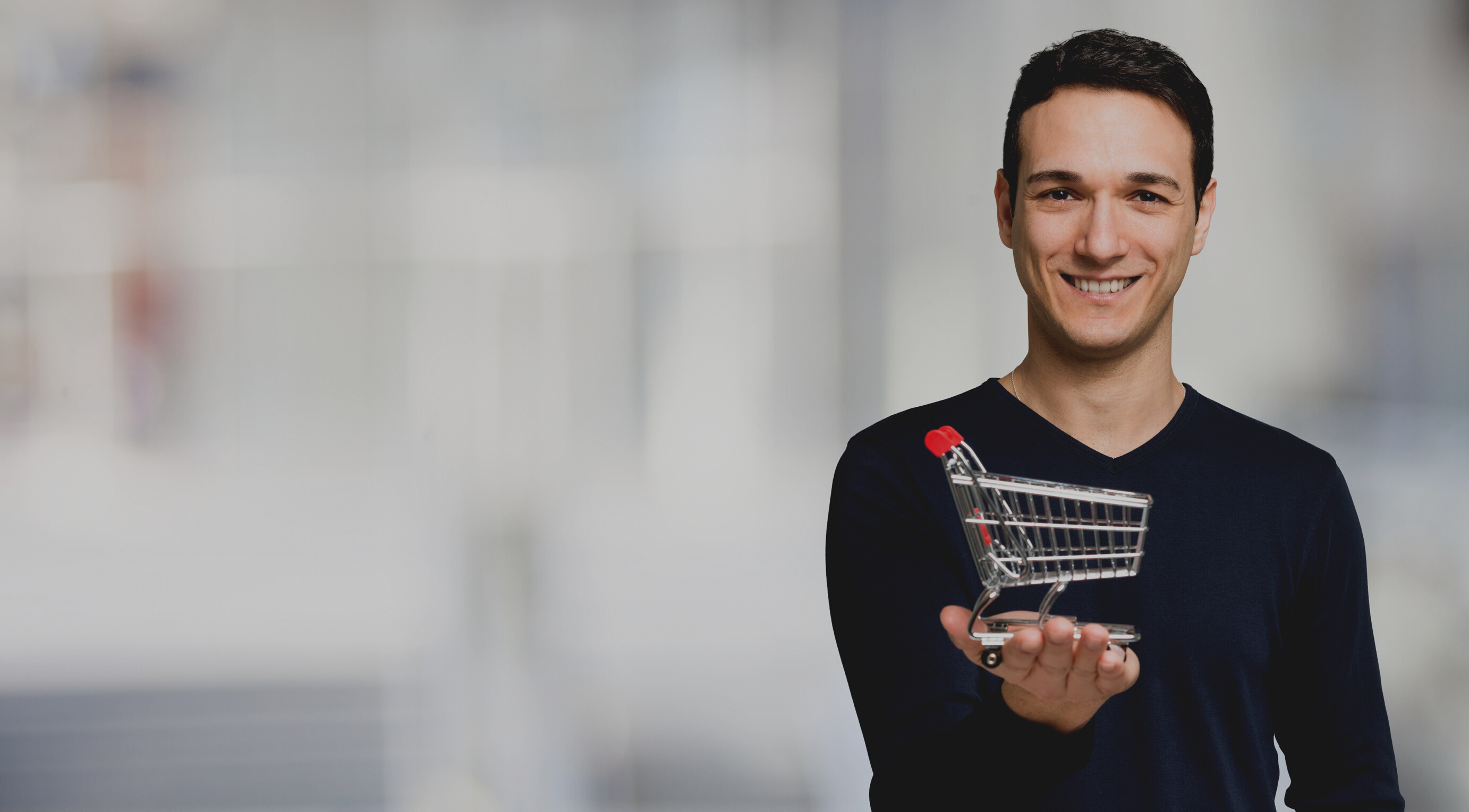 Man Holding Mini Shopping Cart